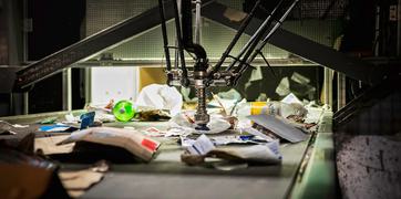 An industrial machine crushing plastics, metals, and paper recycling